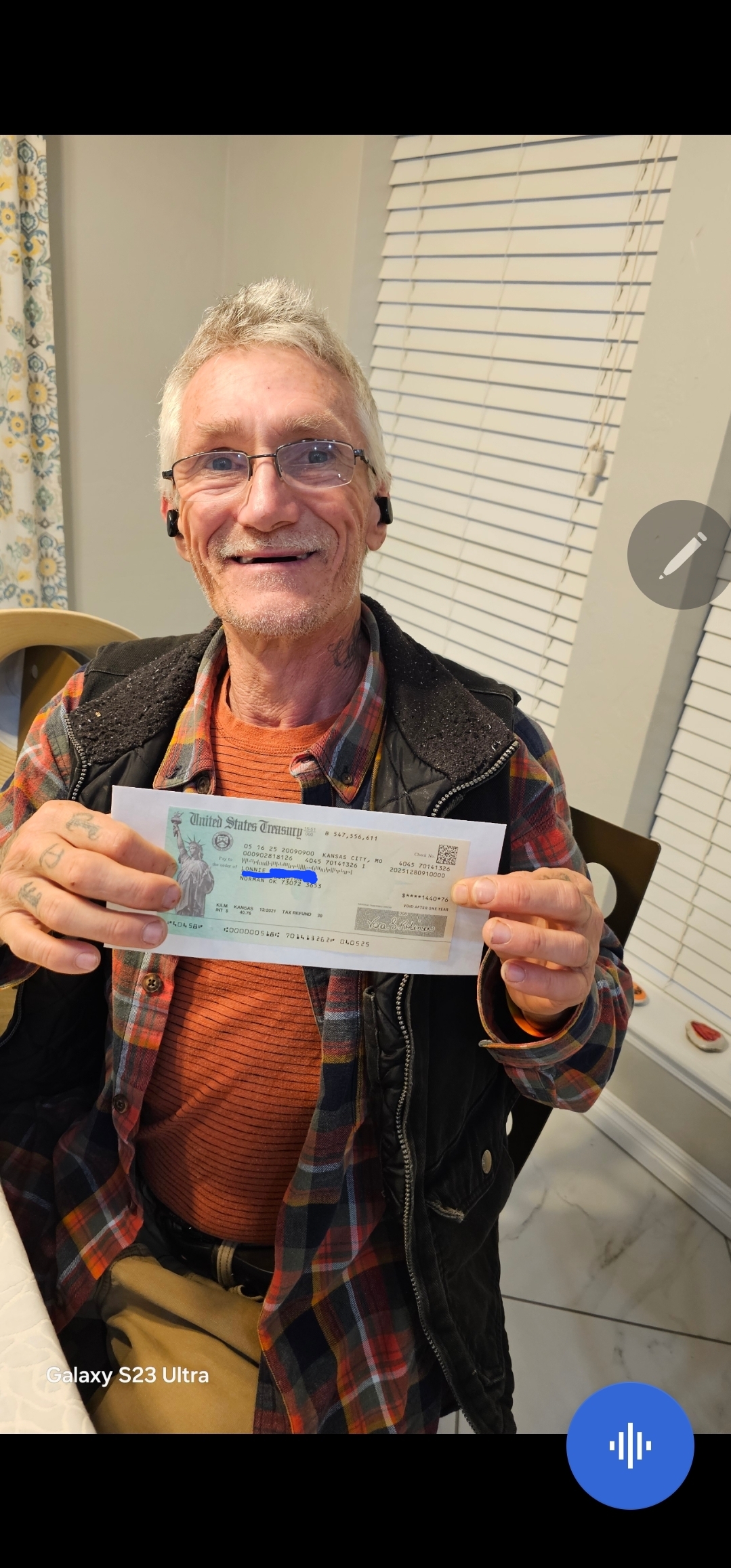 Lonnie holding his stimulus check
